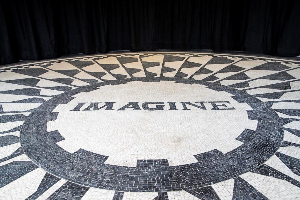 Mosaic in black and white tiles which says "Imagine"