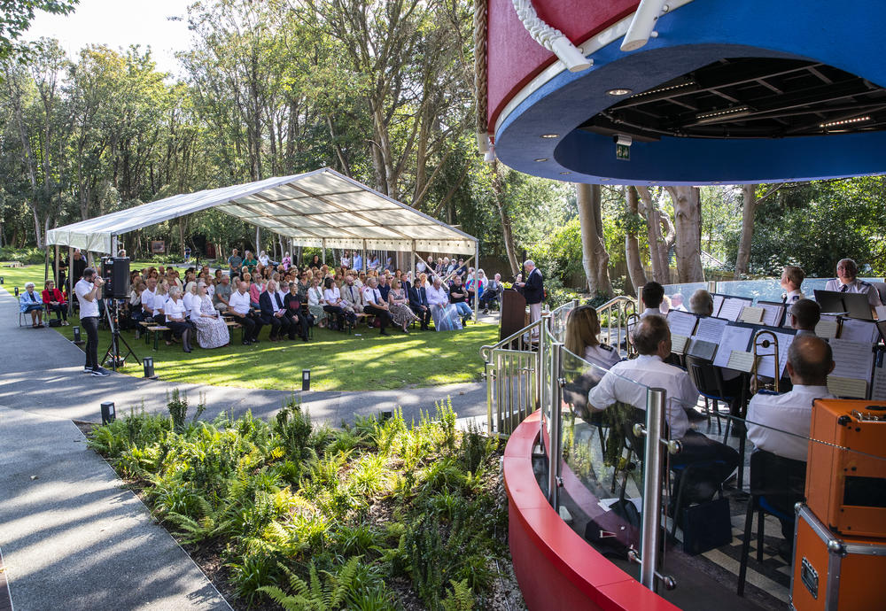 Guests watch Walton Salvation Army Band play at the official dedication of the Strawberry Field Bandstand
