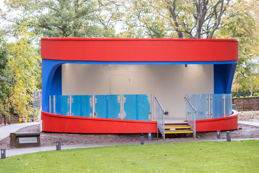 Red and blue bandstand under construction at Strawberry Field